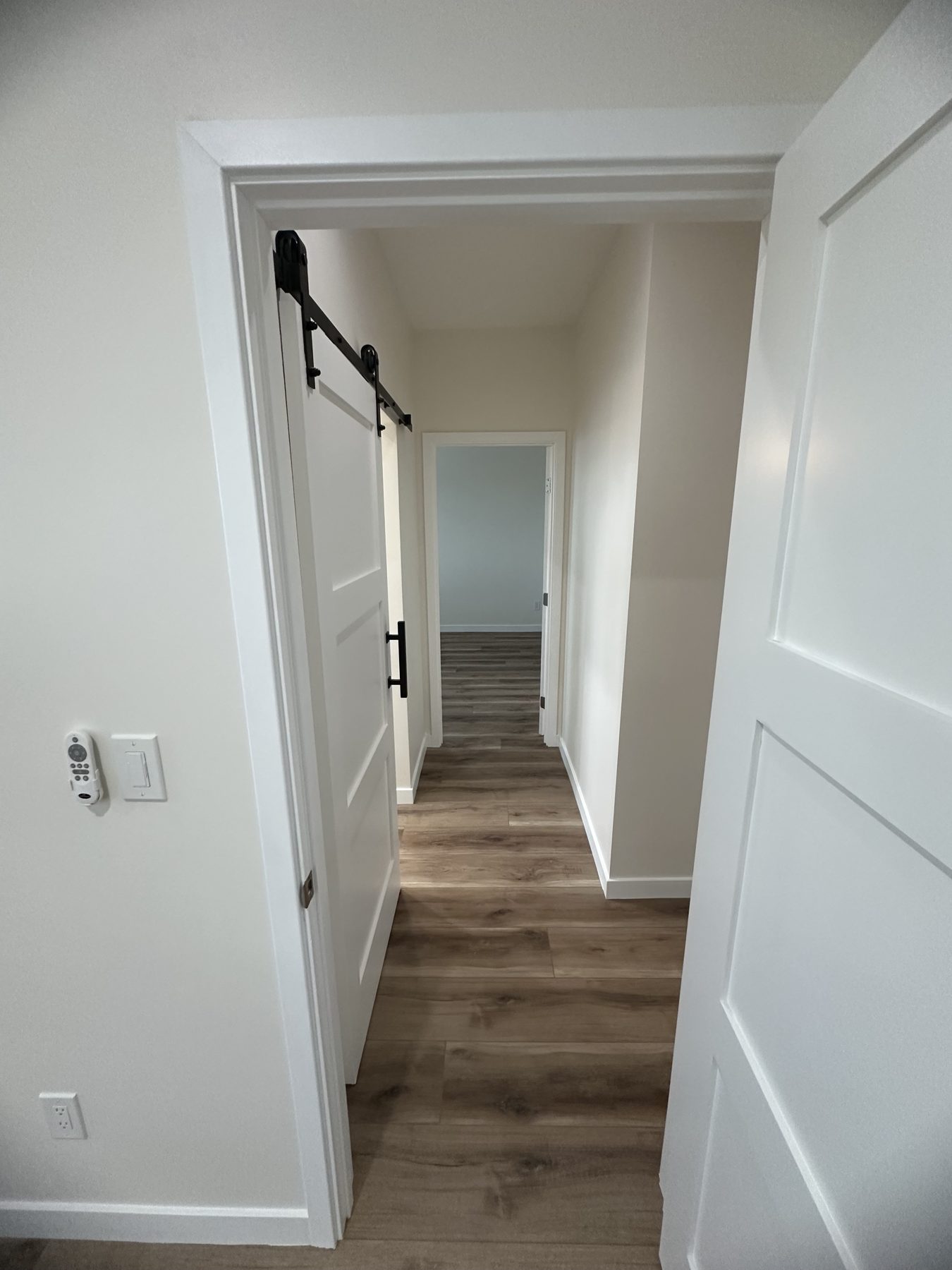 View from a bedroom doorway down the hall to another bedroom at 1148 S Rimpau Blvd
