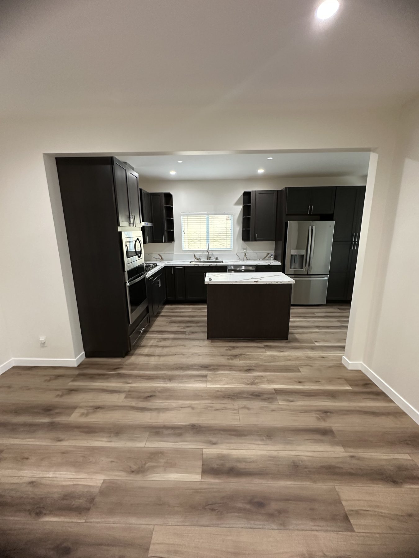 Kitchen with center island seen from the dining area at 1148 S Rimpau Blvd